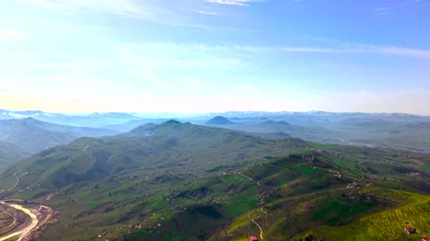 High Altitude Drone Flight Over Lush Green Valley with Light Morning Mist Stock Footage 340317255