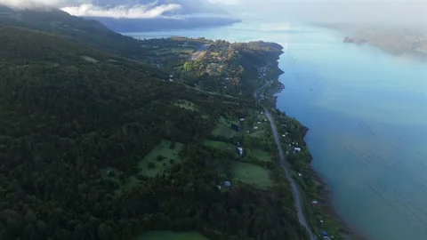 High-Altitude Drone Flight Through Clouds Revealing Mountain Airfield and Fjord 库存影片 334320837