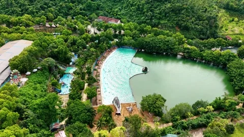 High altitude drone orbit over thermal hot spring pool and water park 4K Stock Footage 341551208
