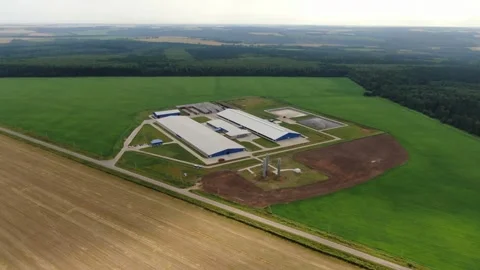 High altitude drone orbiting agricultural complex Stock Footage 333084528