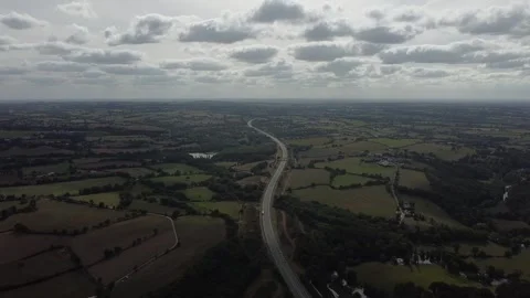 High-altitude drone over fields and highway, France Stock Footage 331709488