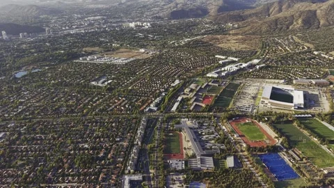 High-altitude drone panorama rotating over the university and surrounding Stock Footage 332559403