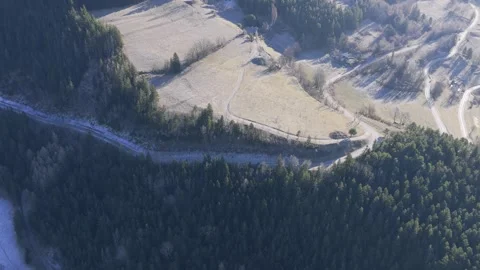 A high-altitude drone shot captures a sweeping view over frosty rural fields and Stock Footage 346676437