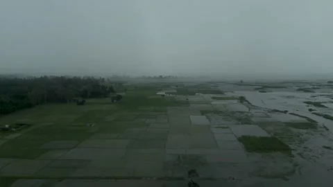 High altitude drone shot of heavy fog and rain front advancing over flooded.. Vídeo Stock 345042496