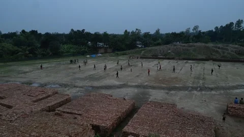 High altitude drone shot of local boys playing outdoors in a village playgr.. Vídeo Stock 345328890