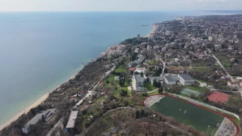 High Altitude Drone Shot Over Coastal Residential Area Near Ocean Shore Видео 332773284