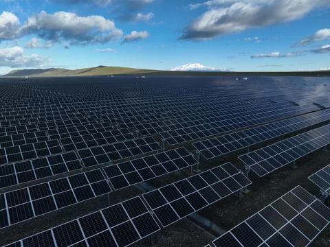 High altitude drone view of large scale solar energy facility Stock Photos
