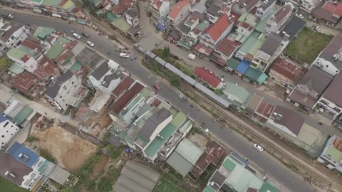 High-altitude drone view of moving train in Da Lat, Vietnam Video stock 319909566