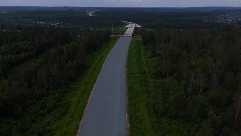 A high-altitude flight over a road construction site and a bridge under con.. Stock Photos