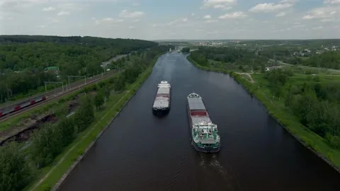 High altitude flying over a cargo commercial ship sailing down the river Video stock 132086626