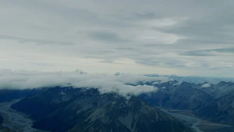 High altitude flying towards cloudy alpine peaks Stock Footage 154988193