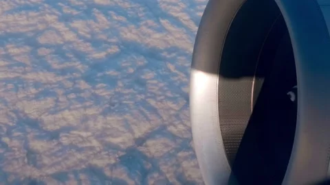 At high altitude, a jet engine of an airplane, and below it, beautiful clouds Stock Footage 323838040