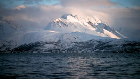High altitude mountains with dramatic cloudy sky and ocean moving in slow motion Stock Footage 121578173