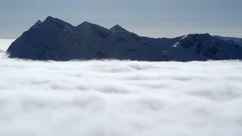 High altitude mountains peeking from cloudy sky troposphere during day time Stock Footage 121577402