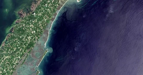 High-altitude overflight aerial of Wallops Flight Center and adjacent coastland. Stock-Footage 70175503