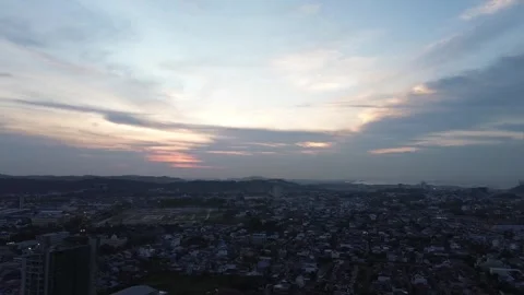 High altitude perspective showcasing a dynamic urban landscape under a pain 動画素材 320106506