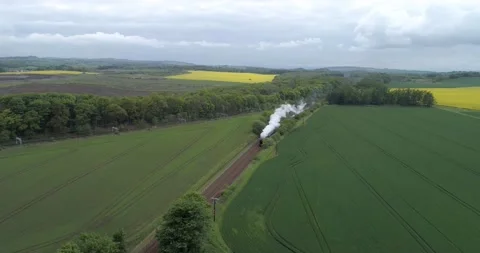 High altitude pull back shot of the Flying Scotsman at full steam cutting Stock Footage 169062510