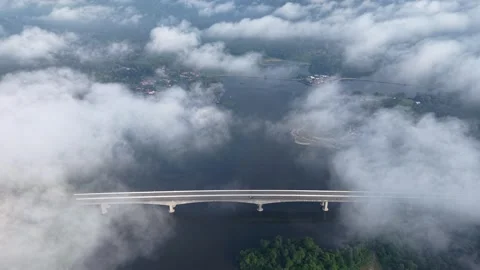 High altitude shot reveals a bridge emerging from clouds Video stock 339864007