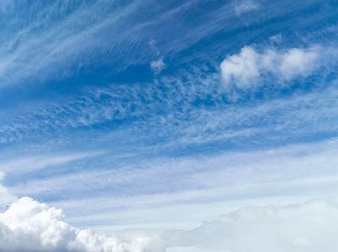 High-altitude sky with delicate cloud patterns over a soft horizon Stock Photos
