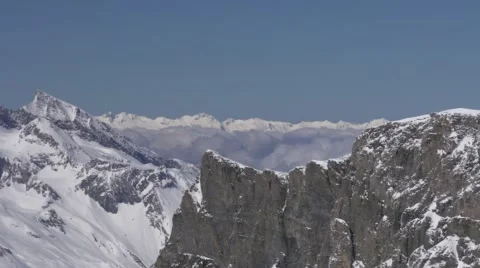 High Altitude Snowy Mountains with Clouds in Valleys. Vídeo Stock 59188625