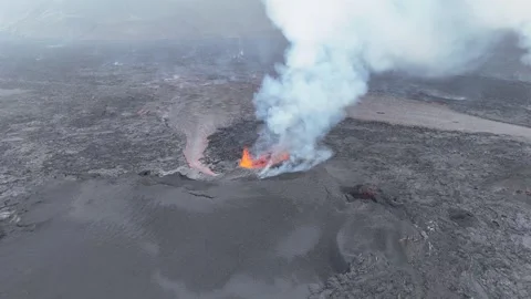 High-Altitude Static Shot of Active Volcano Eruption Over Lava Field in Iceland Stock Footage 321132983