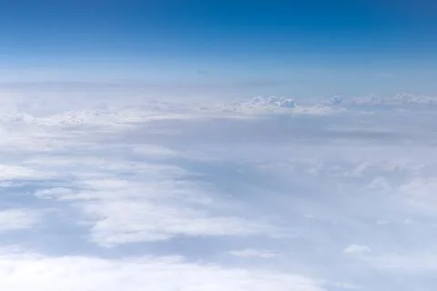 High-altitude view of clouds from airplane window Stock Photos