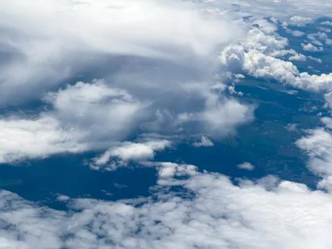 High-altitude view of clouds from airplane window Stock Photos