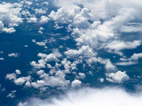 High-altitude view of clouds from airplane window Stock Photos