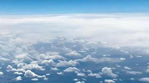 High-altitude view of clouds from airplane window Stock Photos