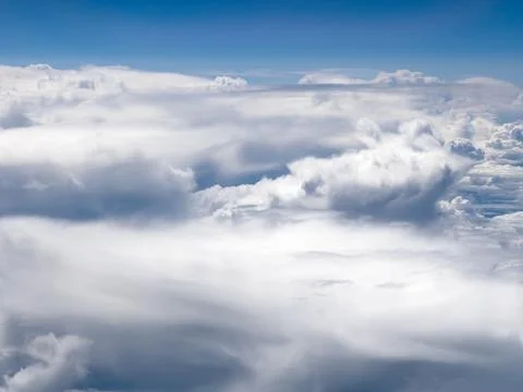 High-altitude view of clouds from airplane window Stock Photos