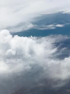 High-altitude view of clouds from airplane window Stock Photos