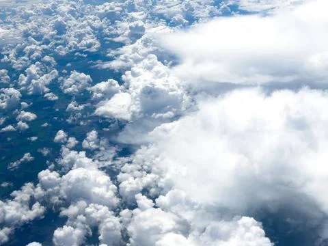 High-altitude view of clouds from airplane window Stock Photos