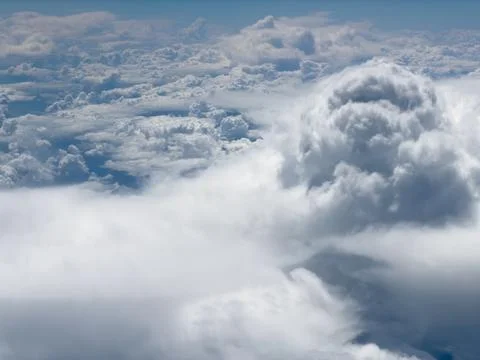 High-altitude view of clouds from airplane window Stock Photos