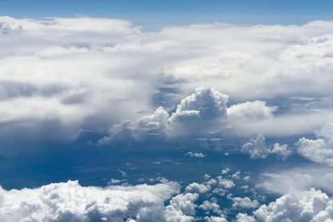 High-altitude view of clouds from airplane window Stock Photos