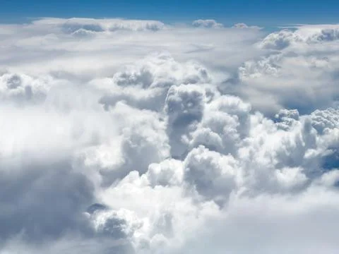 High-altitude view of clouds from airplane window Stock Photos