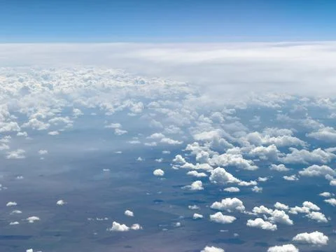High-altitude view of clouds from airplane window Stock Photos