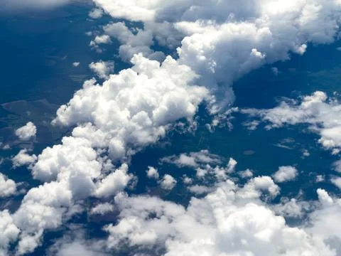 High-altitude view of clouds from airplane window Stock Photos