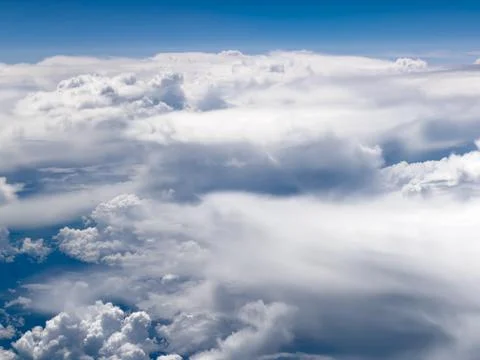 High-altitude view of clouds from airplane window Stock Photos