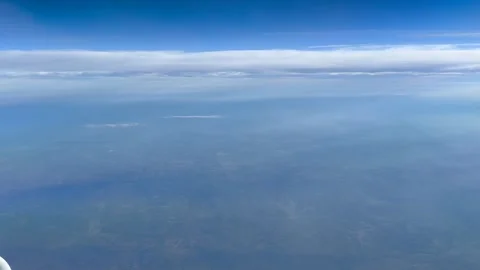 High Altitude View of Clouds and Horizon From a Passenger Plane Stock Footage 277321966