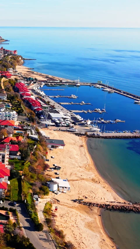 High altitude view of sandy beach and marina coastline Vertical video. Stock Footage 332344076