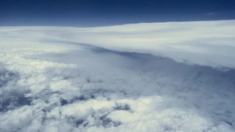 High altitude white clouds and clear sunny blue sky from flying plane Stock Footage 171405627