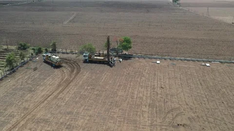 High-altitude wide view overlooking separate construction vehicles parked along Stock Footage 337195525