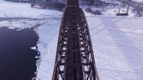 High altitude winter drone shot of icy river and steel bridges Stock Footage 328439879