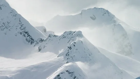 High altitude winter mountains in blizzard weather during day time Stock Footage 121575677