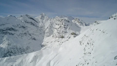 High altitude winter mountains with cloudy blue sky background Stock Footage 121574766