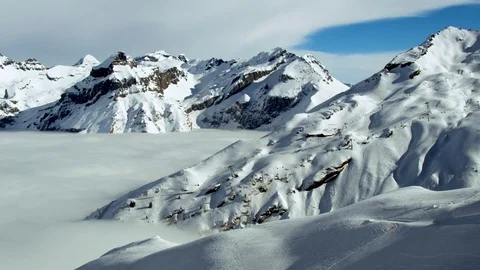 High altitude winter mountains with cloudy blue sky in foggy weather Stock Footage 121579042