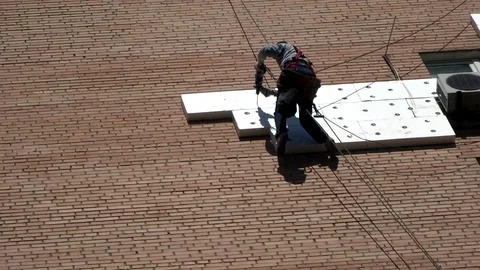 High-altitude work: drilling a brick wall for the installation of insulating mat Stock Footage 91320323