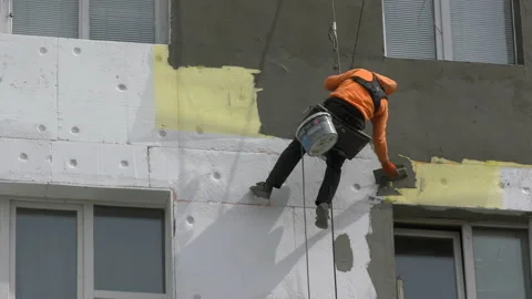 High-altitude work. The man works on high-rise works cladding Video stock 88903968