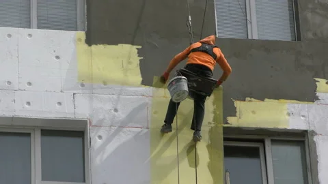 High-altitude work. The man works on high-rise works cladding Video stock 88905058