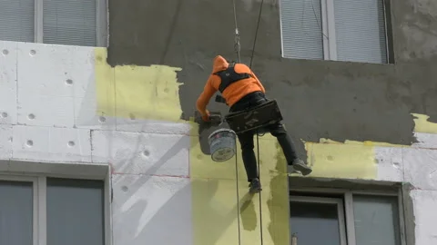 High-altitude work. The man works on high-rise works cladding Video stock 88907360